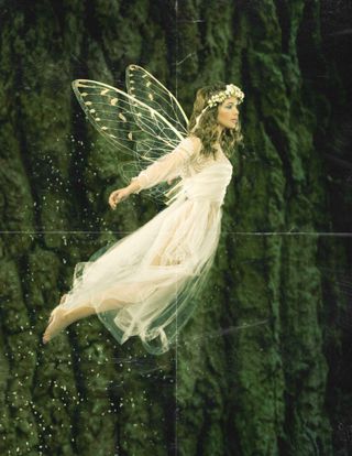 Flying, winged fairy in a long white dress